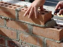 Mixing Mortar laying brick with mortar